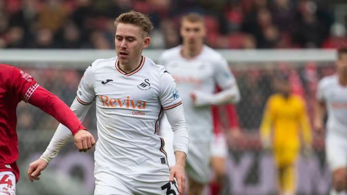 Ollie Cooper in action for Swansea City last season