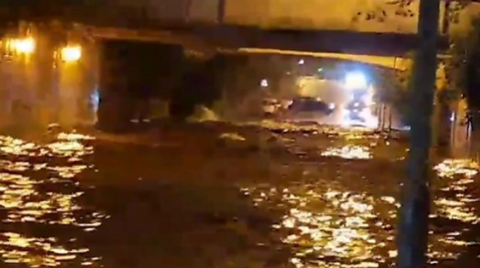 Deep flood waters in yellow street lighting