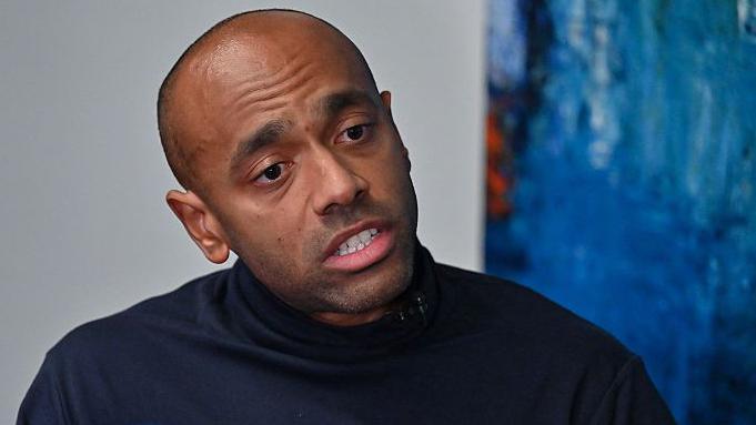 Noureddin Bongo, the son of Gabon's deposed leader Ali Bongo, in a black sweater, takes part in an interview