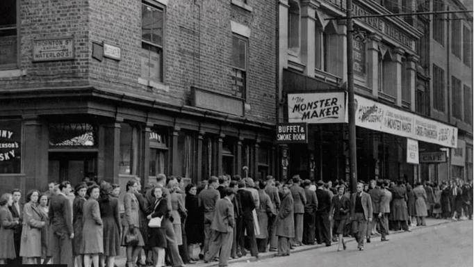 A black and white image of a large queue of people, stretching out of sight round a corner, going to see a performance of The Monster Maker in the 1930s 