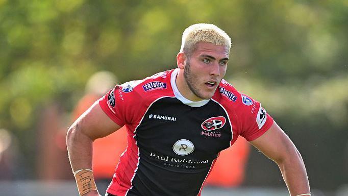 Sol Moody in the red and black shirt of Champ side Cornish Pirates