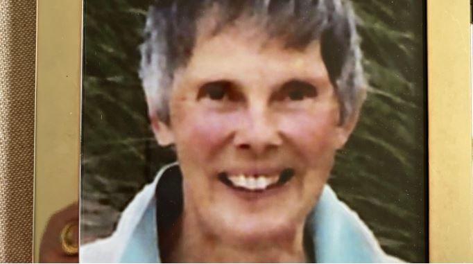 A framed photo of Diana Walker, who smiles at the camera wearing a blue top