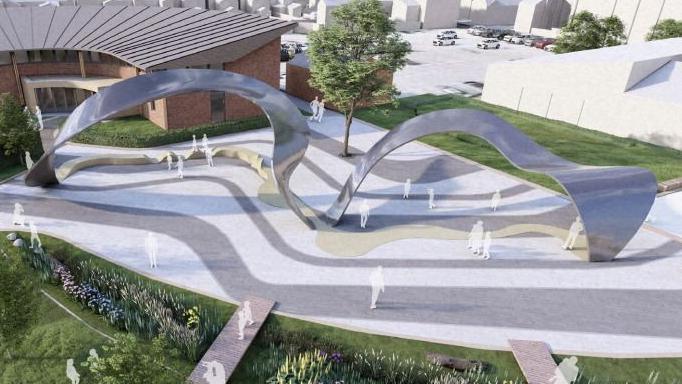 An artist impression of a manicured landscape with a wavy metallic-looking installation spanning across a concrete floor, and is surrounded by a lawn and a building in the top left