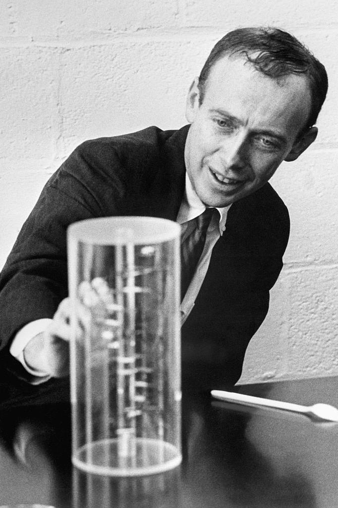 James Watson studying a model of DNA's double-helix structure