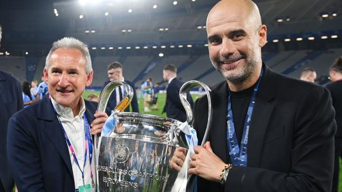 Txiki Begiristain  and Pep Guardiola hold the Champions League trophy