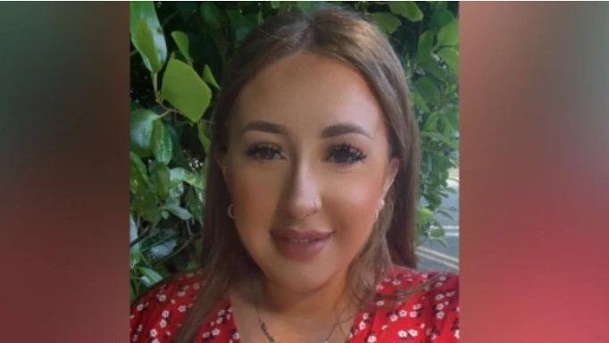 Sarah Montgomery. She has long brown hair and brown eyes, wearing a gold and earrings necklace and red floral top.