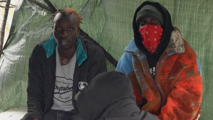 Two men in a tent in Calais