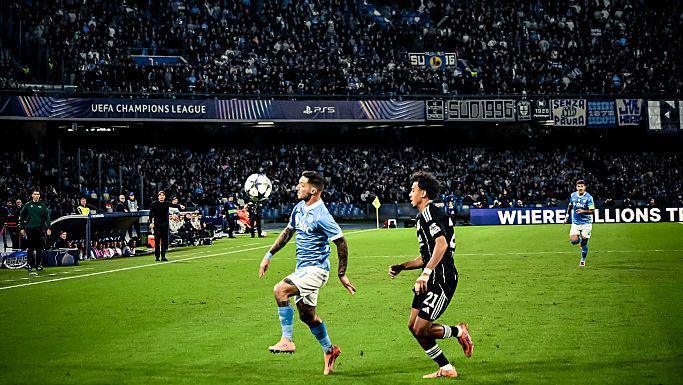 Napoli and Frankfurt players compete for the ball during their Champions League match