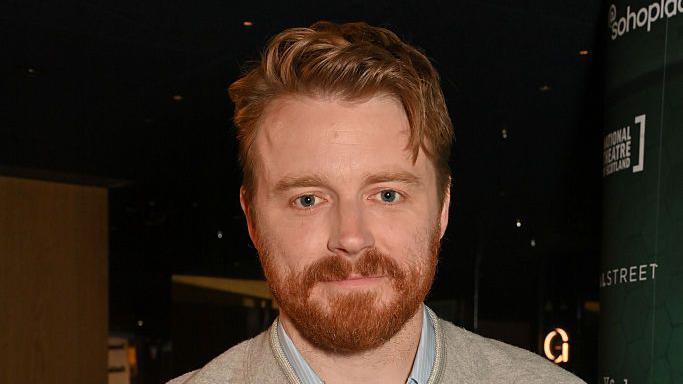 Actor Jack Lowden with a red beard