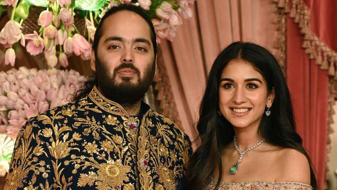Anant Ambani son of billionaire tycoon and Chairman of Reliance Industries Mukesh Ambani (unseen) with his fiancee Radhika Merchant pose for a picture during their Sangeet Ceremony in Mumbai, on July 5, 2024