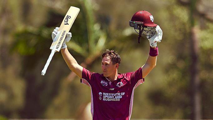 Marnus Labuschagne raising his bat and helmet after hitting a century