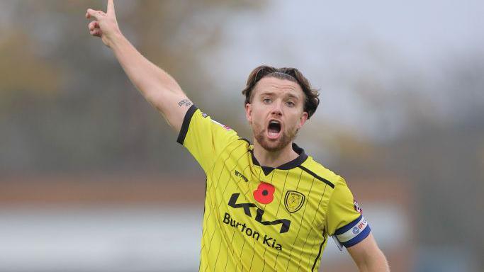 Carl Winchester of Shrewsbury Town and Elliot Watt of Burton Albion during the Sky Bet League One match between Burton Albion FC and Shrewsbury Town FC at Pirelli Stadium