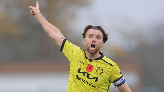 Burton Albion captain Elliot Watt points and shouts