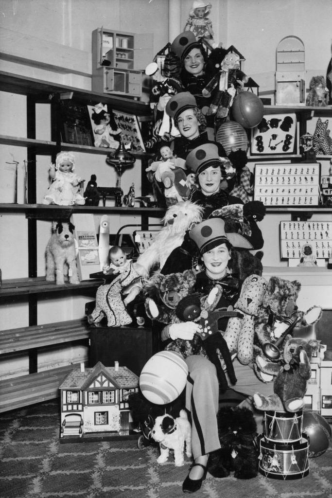 2nd November 1936: Shop assistants in their 'Toyland' uniforms prepare for the Christmas rush at Whiteleys, Queensway, London. (Photo by George W. Hales/Fox Photos/Getty Images)