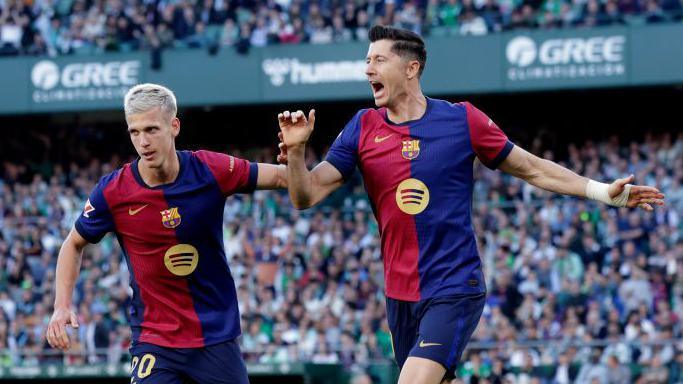 Robert Lewandowski celebrates scoring for Barcelona against Real Betis