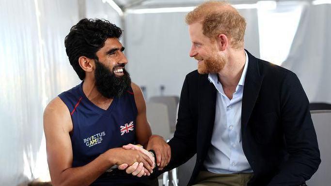 Wali shaking Prince Harry's hand