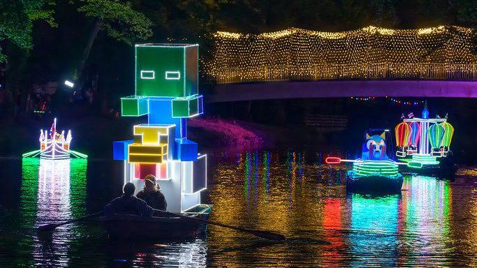 A parade on the water of brightly lit boats