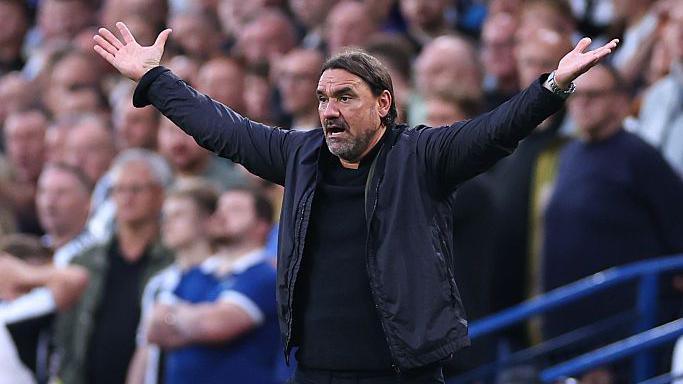 Daniel Farke holds his arms aloft in frustration