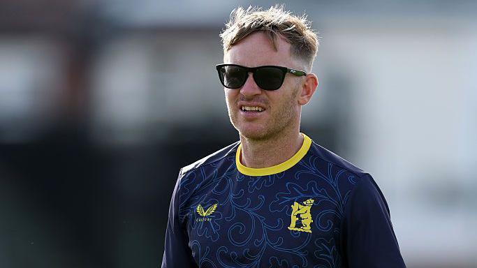 Ian Westwood takes a training session in his navy blue Warwickshire T-shirt. He is wearing sunglasses