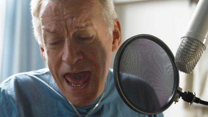 Mature man singing into a microphone