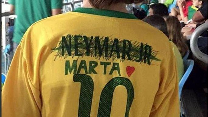 Screengrab of a tweet by Danielle Warby showing a boy wearing a Neymar replica jersey with the name crossed out and that of Marta drawn on