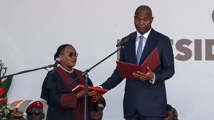 Daniel Chapo wears a dark blue suit with a light tie as he is sworn in as Mozambique's fifth president 