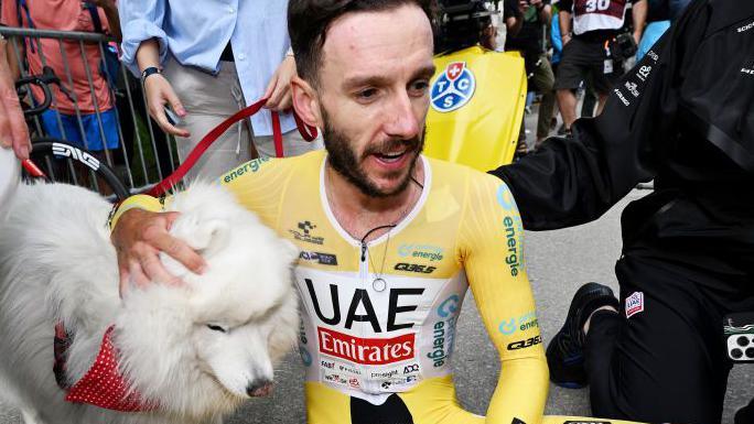 Adam Yates strokes a dog