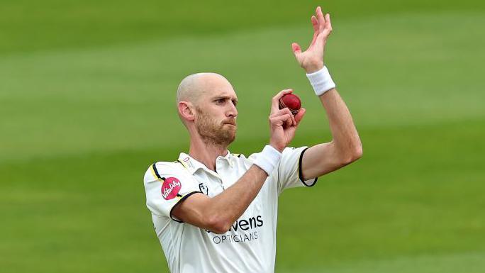 Olly Hannon Dalby bowls a ball during a match