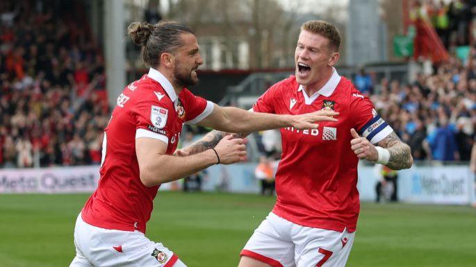 Wrexham striker Jay Rodriguez (L) celebrates with team-mate James McClean 