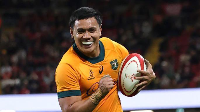 Len Ikitau smiles as he scores a try for Australia