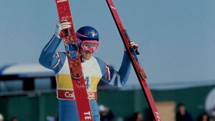 Eddie the Eagle Edwards holding his skis after competing a jump at the 1988 Winter Olympics