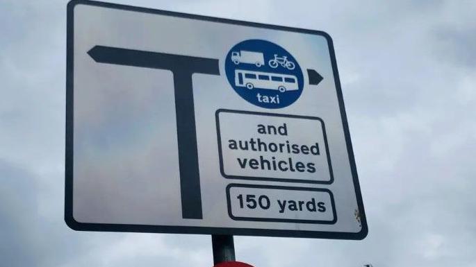 Bus gates sign in Aberdeen, showing where certain vehicles are allowed to travel, with clouds in the background