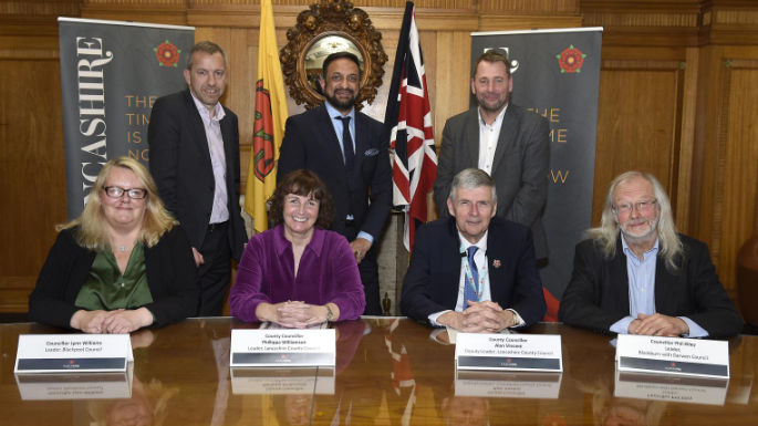 An image of the leaders involved in the new authority, smiling alongside their name-plates