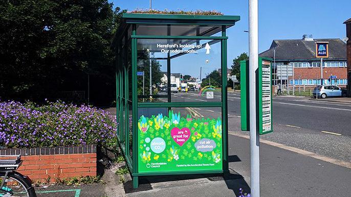 Image of an existing green bus shelter in Hereford