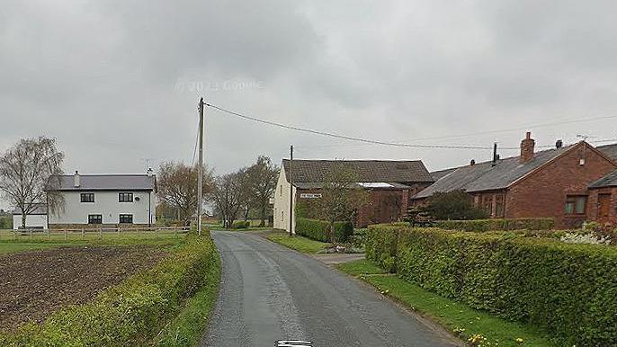 Houses amid fields in Fir Tree Lane, Aughton