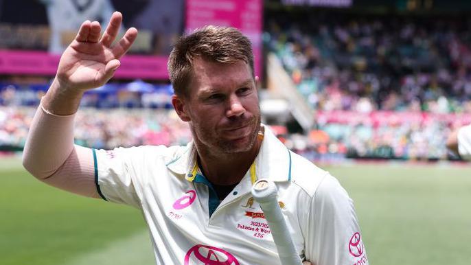 Australia opener David Warner waves as he walks off the pitch