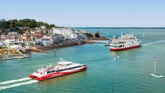 A stock image of a Red Funnel ferry ad fast car ferry in the sea