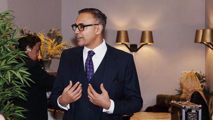 Jas Bains in a smart suit in a swanky bar restaurant talking to people who are out of shot