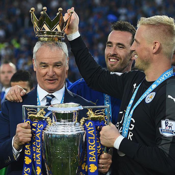 Claudio Ranieri with the Premier League trophy and a crown being put on his head