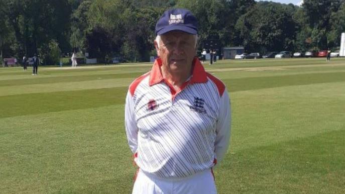 Mick Kenyon wearing his cricket gear in a field 