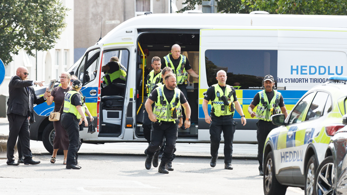 Police officers coming our of a van