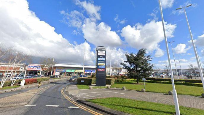 A Google view of the entrance to Kingswood Retail Park in Hull. A road leads to the shops off a roundabout and a "Kingswood Retail Park" sign.