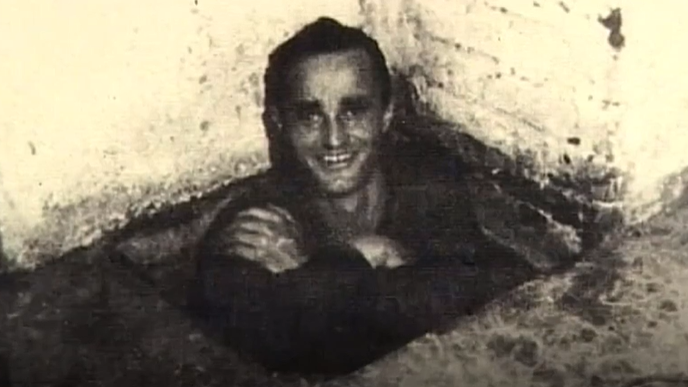 Dick Churchill smiles at the camera in a black and white photograph.