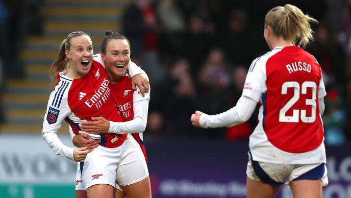 Alessia Russo and Caitlin Foord celebrate with Beth Mead after she added Arsenal's third goal of the game