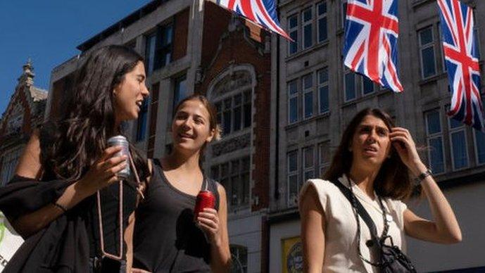 People walking along Oxford Street in May