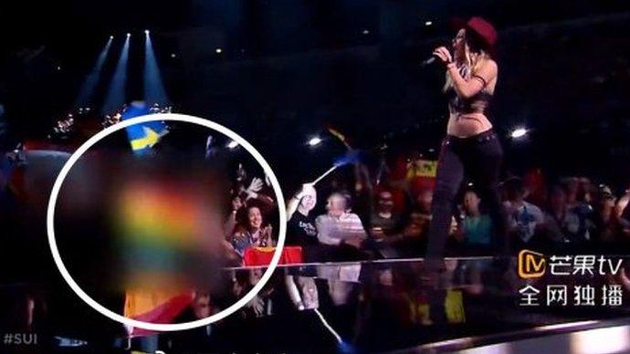 Screenshot of Switzerland's Eurovision performance with a rainbow flag in the audience blurred out and circled