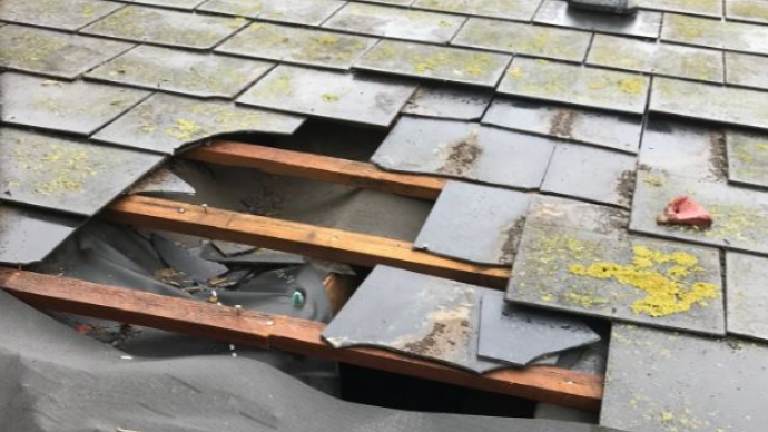 Missing and broken slates on the homeowner's roof