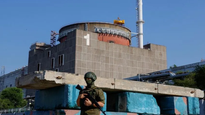 A soldier stands outside the Zaporizhzhia nuclear plant in June 2023