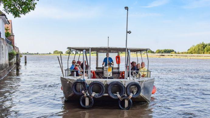 People on the West Lynn ferry on the River Ouse.