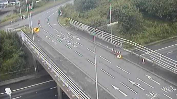 A CCTV image of the motorway bridge over the M62, it shows damage to the barrier